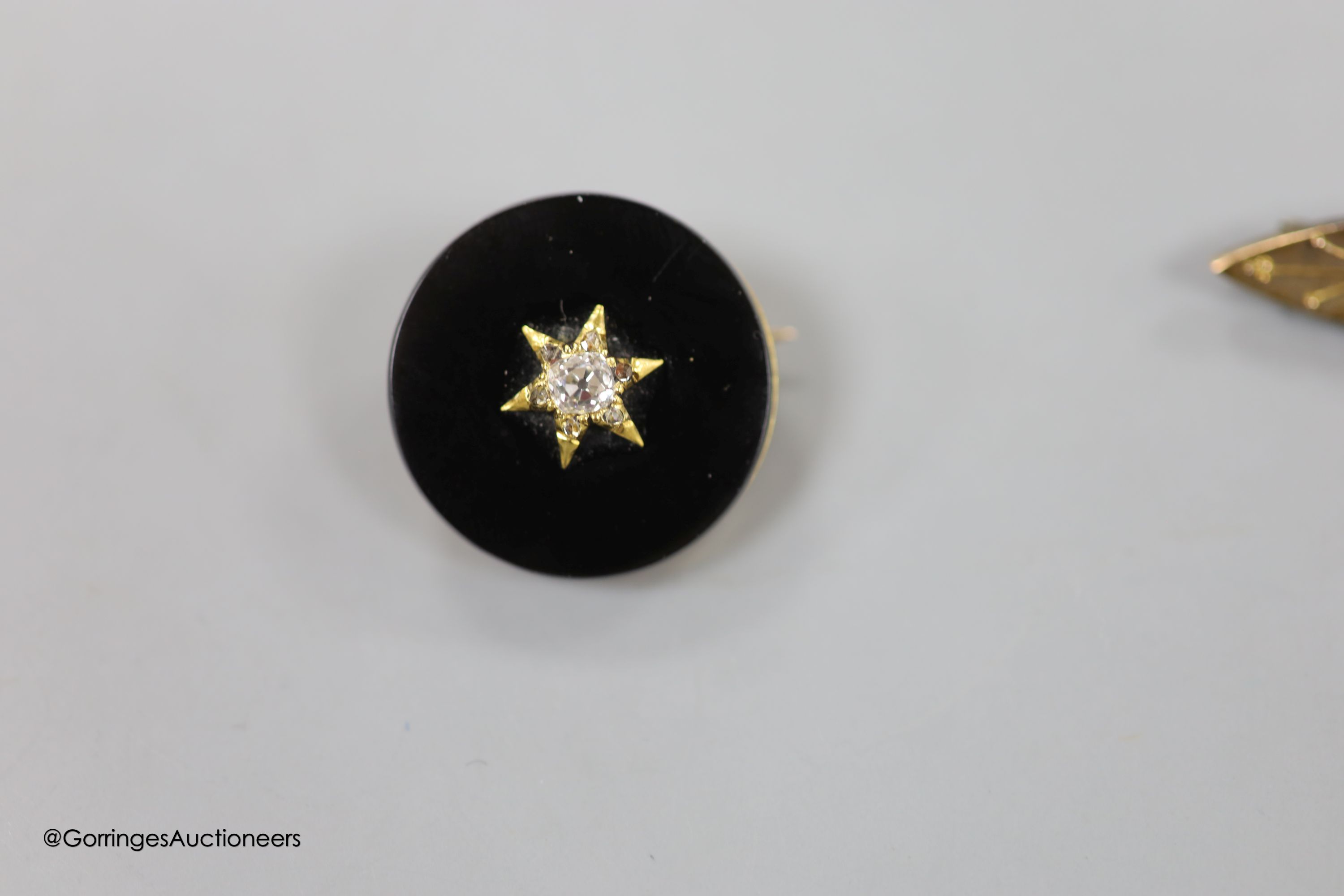 A 9ct three-colour gold puzzle ring, a Victorian yellow metal, 4.8 grams, rose diamond and onyx mourning brooch and four other items